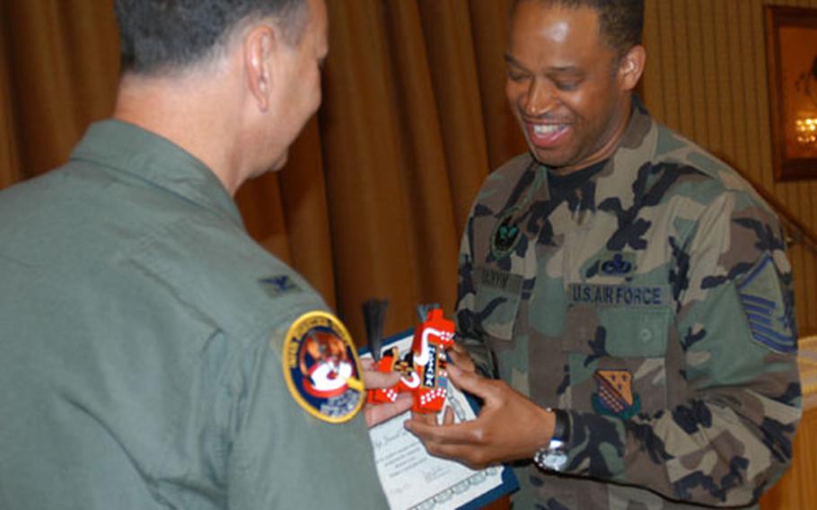 Misawa Air Base's 35th Fighter Wing Vice Commander, Col. Don Weckhorst, thanks Master Sgt. Jamal S. Qaiyyim for his volunteerism at an awards luncheon last week. Qaiyyim developed and teaches courses for the Family Support Center and tutors at Cummings Elementary School, among other charitable work.