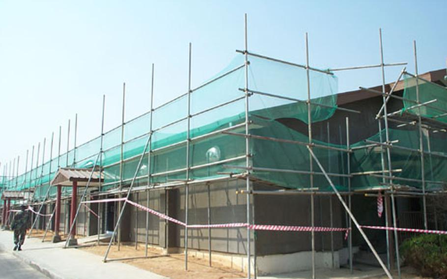 At Camp Humphreys, a U.S. Army helicopter base in South Korea, scaffolding is up around the building being refurbished for use as a spacious new home for the base bank, credit union, and post office. The structure, built in 1972, served as post exchange until a new one opened last year.
