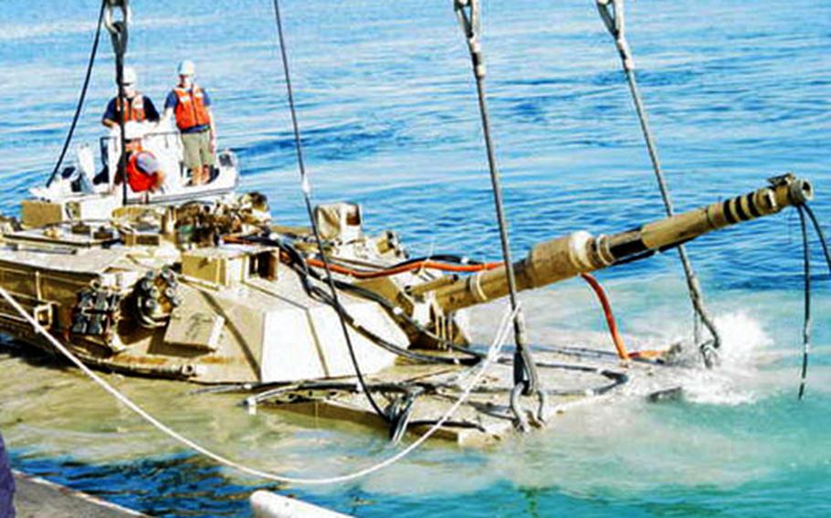 An M1A1 Abrams battle tank that sank to the bottom of Guam’s Apra Harbor is lifted after three weeks of preparations. The tank fell off a U.S. Navy Landing Craft Air Cushioned hovercraft on Feb. 17.