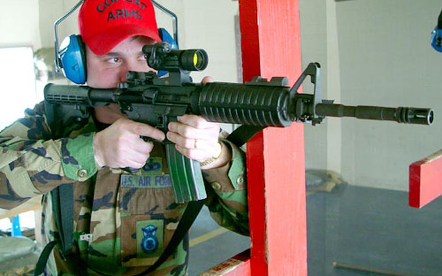 Air Force Staff Sgt. Jeremy Potts takes aim with the M4 carbine earlier this month at Osan Air Base in South Korea, where security forces and other airmen are making the switch to the M4 from the M16A2 rifle. Potts is a combat arms instructor with Osan’s 51st Security Forces Squadron.