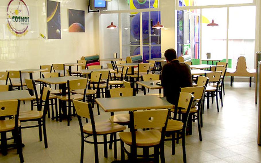 A customer has a late lunch at the Cosmos food court at Naval Station Rota, Spain, on Wednesday. The Navy is closing the Morale, Welfare and Recreation department's struggling food court six months after it opened for business.