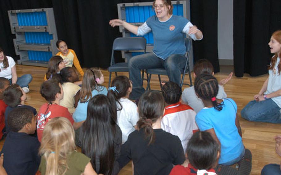 Actor/director Jessica Nievinski teaches students from Arnn Elementary School at Sagamihara Housing Area the songs for Cinderella, a performance with the Missoula Children's Theatre.