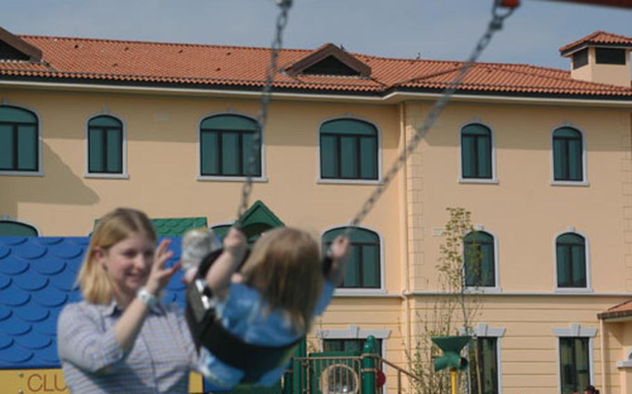 Nicol Gecewich pushes her 2-year-old daughter Kaylie on the swing in a playground surrounded by the four temporary living facility units at Aviano Air Base, Italy. The playground is finished, but the suites — designed to house families processing into and out of the base — won't be open for a few months. A handful of projects in the $564 million Aviano 2000 construction program are set to open in the fall.