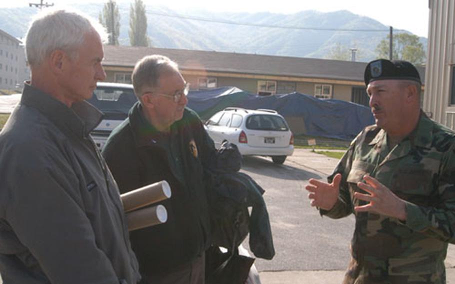 Command Sgt. Maj. James Lucero (right) explains "sergeant's time" training to Association of the US Army representatives Jim Ryan (left) and Norm Harkins.