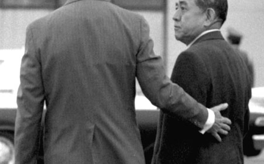 Agnew and Sato leave the airport after welcoming ceremonies.