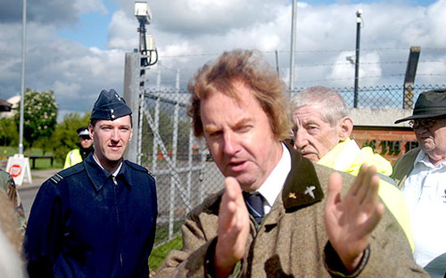 Royal Air Force Squadron Leader James Savage, left, listens Wednesday as Martin Storey, a local councilor, talks about traffic around RAF Feltwell, England. Local residents want traffic around the U.S. base cleared.