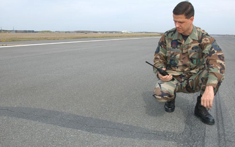 Master Sgt. Johnny Duraccio, chief of airfield management for the 35th Operations Support Squadron at Misawa Air Base, Japan, checks on an extensive surface crack in the base's asphalt runway. The airstrip will close June 4 through June 17 for major repairs.