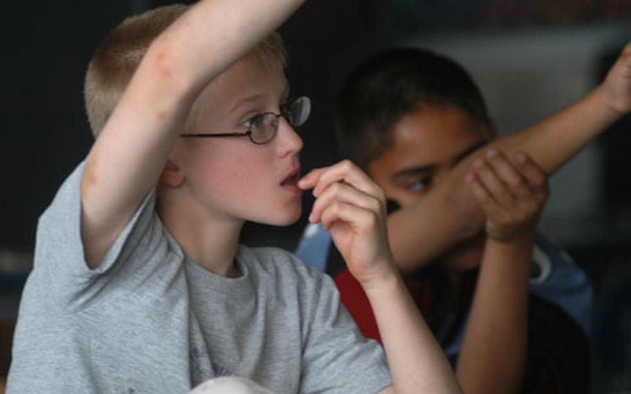 Cody Bergen, left, and Bryan Acosta, 11, ask questions during a Risk Watch water safety class at Naples Elementary School.