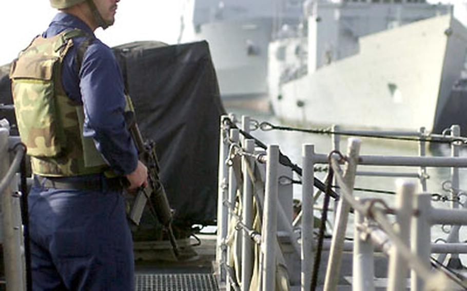 A sailor stands guard aboard the USS Typhoon.