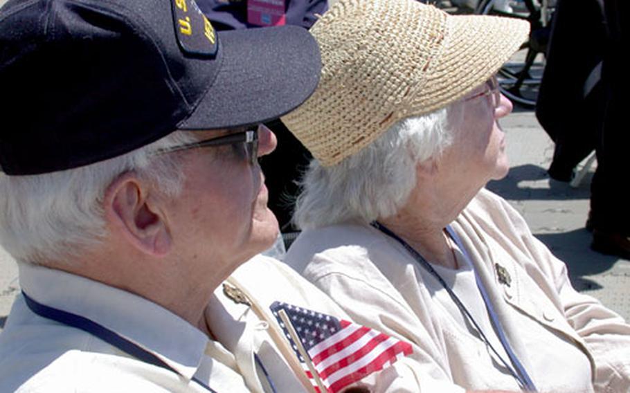 WWII veteran Bob Brennan, 80, listens with his 77-year-old wife, Alice, to a speech by former senator and WWII veteran Bob Dole Saturday afternoon. Brennan and six others were held as prisoners of war by the Germans for 13 months after their B-17G Flying Fortress was shot down over Germany on Feb. 22, 1944.