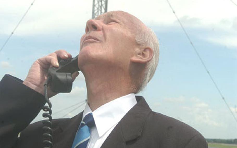 Ron Pearson, 75, who served as a Royal Air Force air traffic controller at RAF Mildenhall, England, in 1950, makes the final radio transmission from the control tower at the base Sunday afternoon. A new tower is now working. The final radio call was made to a British Lancaster bomber from World War II that flew low over the base.