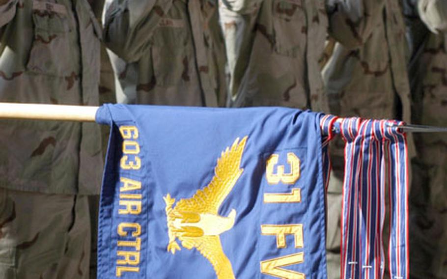 Members of the 603rd Air Control Squadron salute during the playing of the national anthem at a ceremony Thursday welcoming them back to Aviano Air Base from a six-month deployment to Iraq.
