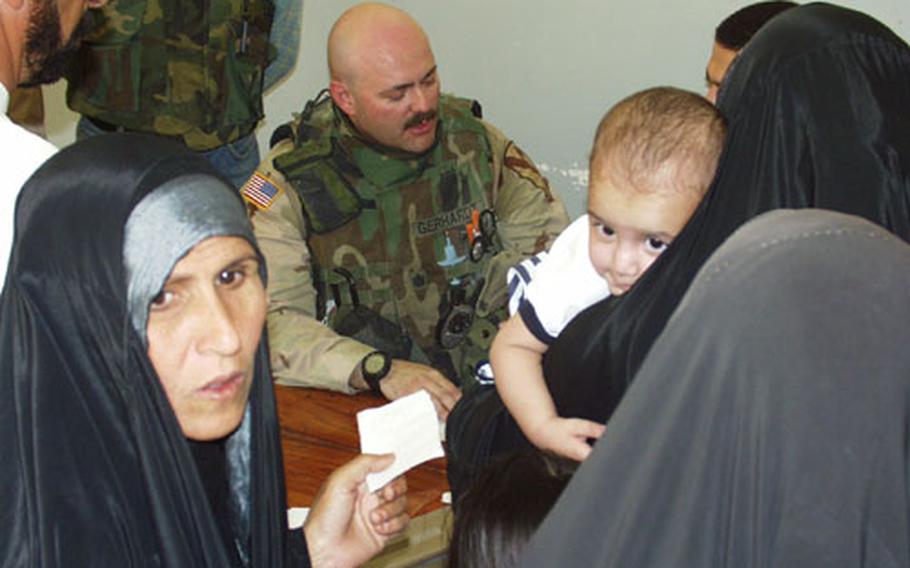 Lt. Col. Robert Gephardt, a doctor with 1st Battalion, 12th Cavalry Regiment, sees patients Thursday at a medical clinic in the village of Al-Rashad, located on the northeastern side of Baghdad next to the crime-ridden Sadr City area.