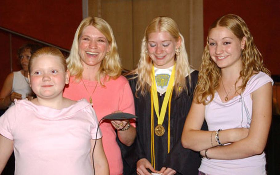 Hanau High School valedictorian Amber Maultbay and family talk with Amber's dad, 1st Sgt. Clifton Maultbay, via a video teleconference following Hanau's graduation Thursday. Sixteen Hanau graduates have a parent deployed. Pictured from left to right are: Brittany Maultbay, 10; Rhonda Maultbay; Amber Maultbay; and Kristin Maultbay, 14.