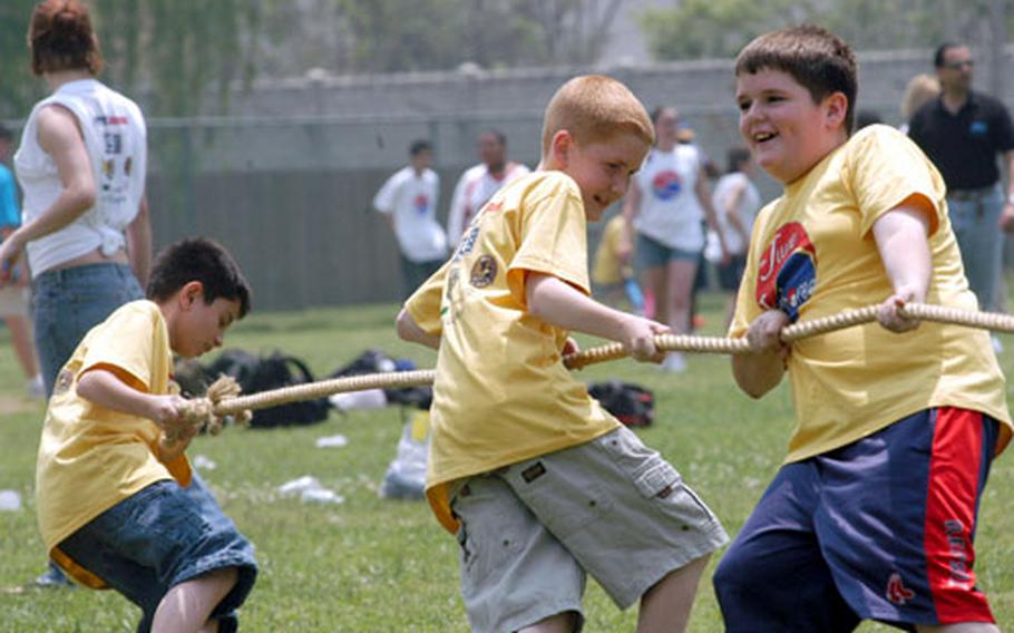 Kids participate in a tug-of-war Friday at the June Jamboree, a day of activities for special needs kids in the Army's Exceptional Family Member Program.