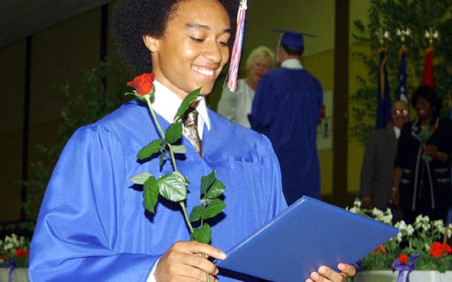 Richard Gomez smiles after receieving his diploma Friday at Ramstein High School's graduation. Gomez was one of 203 seniors to graduate Friday at Kaiserslautern's Barbarossahalle in Germany.