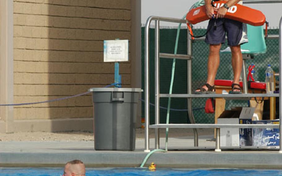 Chief Warrant Officer 2 Al Chapman, a Black Hawk pilot deployed in Kuwait, takes a break from Army life by volunteering as a lifeguard at the pool at Camp Arifjan, Kuwait, on the weekends.