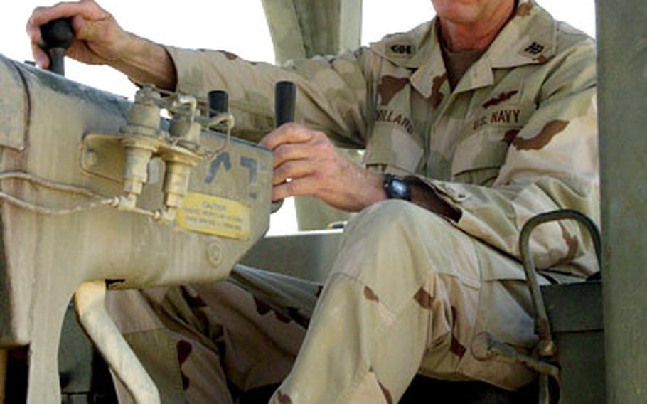 Master Chief Beryl Millard, 57, of the 14th Naval Mobile Construction Battalion, on a bulldozer at al-Asad, Iraq. Millard operates a 40-ton crane at his job back home in Tampa, Fla.
