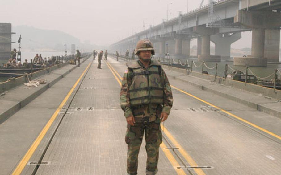 Captain David Stewart, Commander of the 2nd Infantry Division's 50th Engineers Company, stands on a floating bridge built by U.S. and South Korean engineers over the Han River on Thursday.