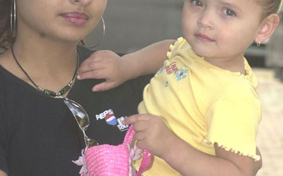 A firm date for the return of the 1st Armored Division is "the best news," said Samira Herrera Diaz, holding daughter Kassandra, 2.