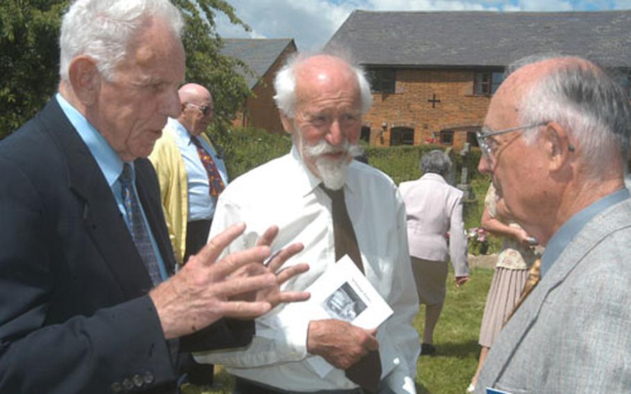 Keith Anderson, left, and Russell Reed, right, former B-17 pilots with the 398th Bomb Group, talk about flying with Mike Graty, center, who flew Lancaster bombers for the Royal Air Force during World War II. The three men talked after a service of thanksgiving at St. George's Church in Anstey, England, honoring the men of the 398th who died in the war.