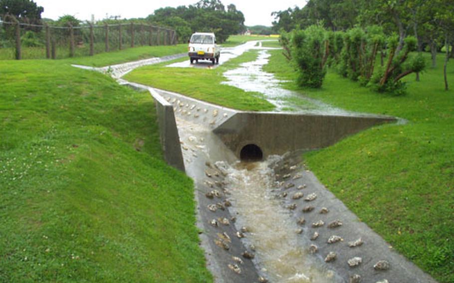 Before this culvert was installed along the Marine Corps Air Station Futenma baseline, water would run into a local elementray school's basement.