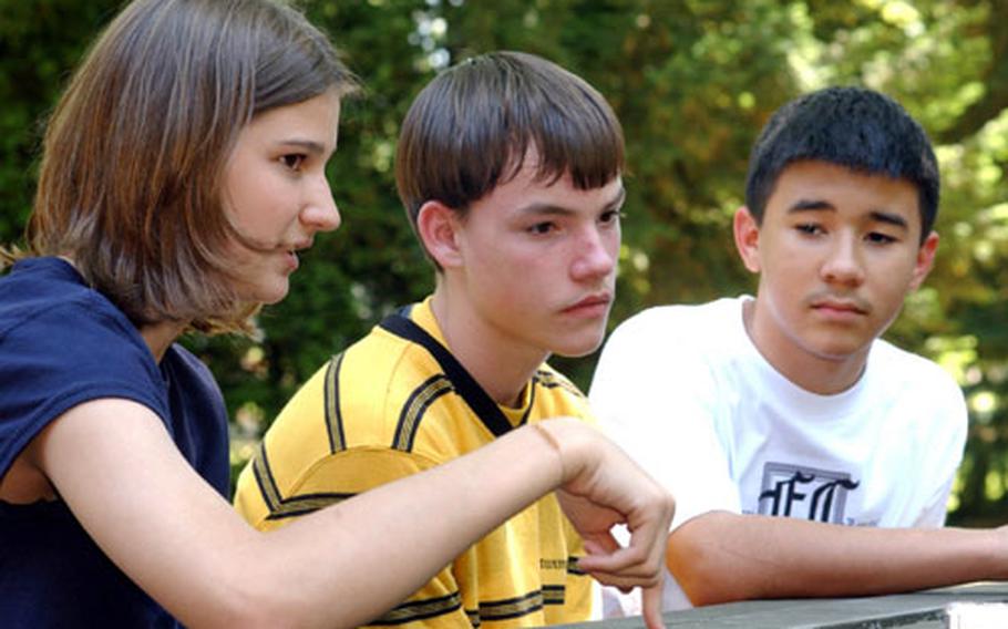 From left, 14-year-olds Rachel Kodalen, Kris Higgins and Grant James discuss the effects of their fathers being deployed to Iraq during a round-table discussion with Stars and Stripes and counselor Frankie Nielsen at Wiesbaden Middle School last week.