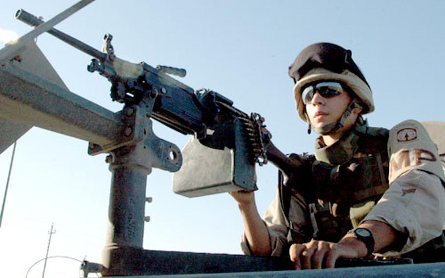 Spc. Stephen Lord, 19, of Allenstown, N.H., mans a machine gun atop an armored Humvee. Lord’s platoon is escorting a convoy of civilian trucks from Balad to Baghdad, 30 miles through one of Iraq’s most dangerous zones.