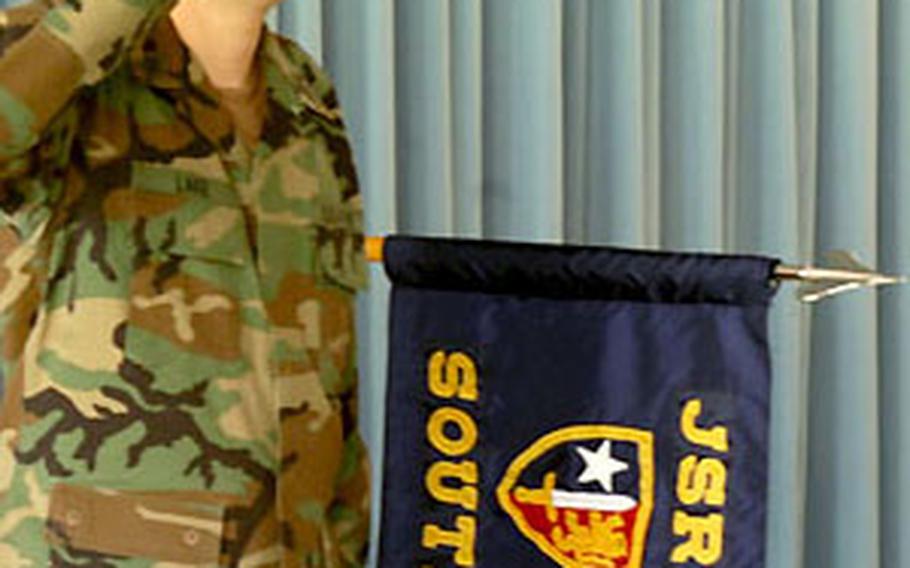 During a deactivation ceremony Wednesday, First Sgt. Robert Lake, commander of the detachment of Army soldiers assigned to Verona, Italy, salutes as the national anthem is played. A few minutes later, Joint Command South’s colors were folded and put away.