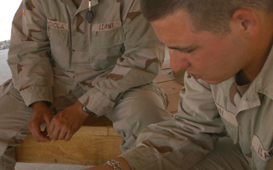 Sgt. Fred Mendiola, left, and Sgt. Christopher Mann remember the good times with Sgt. Arthur Mastrapa, a 351st Military Police Company soldier killed Wednesday in Balad, Iraq.