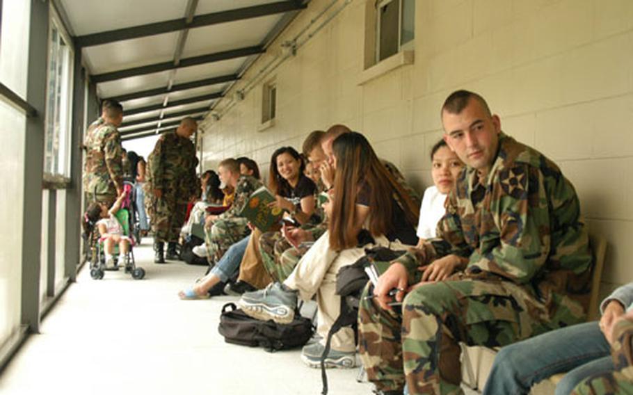 Families wait to be briefed at the Desert Strike Family Readiness Exercise on Friday.