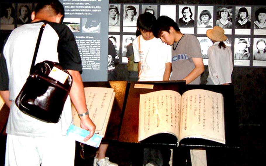 Visitors to the Himeyuri Peace Museum read the testimonies of girls pressed into service as nurses' aides during the Battle of Okinawa.