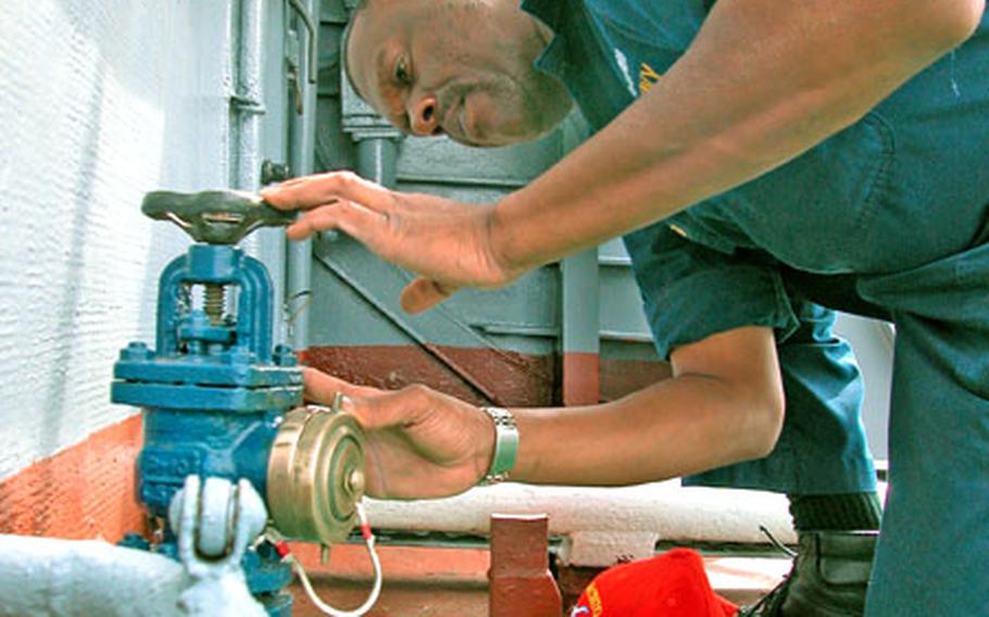 Senior Chief Petty Officer William Bridgeforth of USS San Jacinto looks at a fireplug and other firefighting equipment on the Russian frigate Neustrashimy. Bridgeforth and Petty Officer 3rd Class Darrell Crawford spent the day aboard Neustrashimy during Baltic Operations 2004.