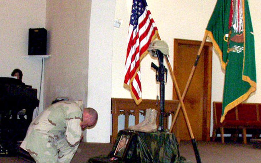 1st Sgt. Mark E. Porrett reflects on the loss of a fellow soldier he described as "a true patriot and warrior" during Wednesday's tribute in Hanau, Germany, to Spc. Thai Vue, a mechanic with the 127th Military Police Company who died in Iraq last week.