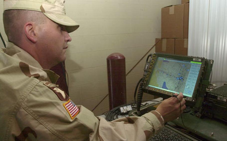 Army Maj. Michael Martyn, Blue Force Tracker program manager, demonstrates the system's capabilities by showing equipped vehicles currently on the ground in Iraq. Martyn pulled them up on the screen from a warehouse on Camp Arifjan, Kuwait.