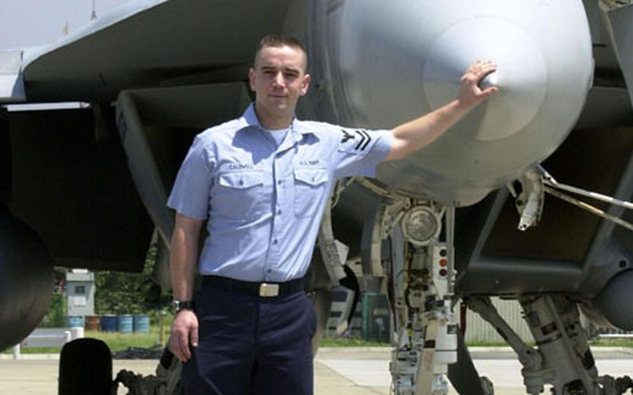 Petty Officer 2nd Class John Caldwell was rescued at sea after he fell off the USS Kitty Hawk's flight deck while performing an inspection on an F-18 Super Hornet.