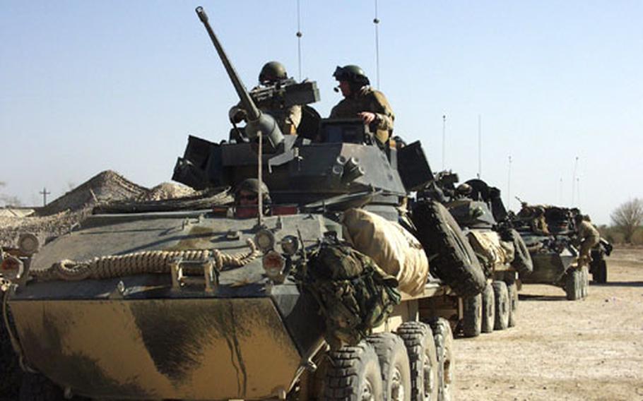 A platoon of Marines from Company D, 2nd Light Armored Reconnaissance Battalion, head out on Friday to patrol the main highway along the eastern edge of Fallujah, Iraq. Each of the Light Armored Vehicles, called LAV-25s for their 25 mm Bushmaster chain gun, carries seven Marines.