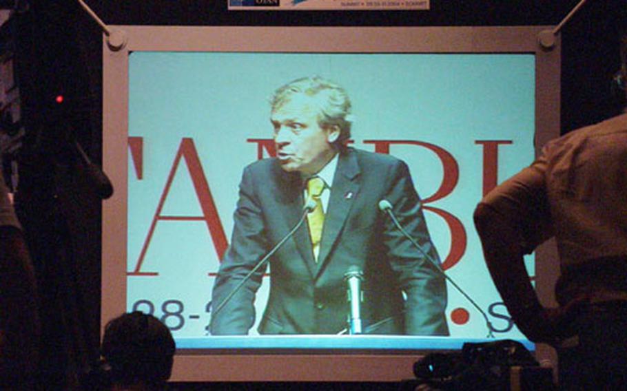 A super-size, televised NATO Secretary General Jaap de Hoop Scheffer addresses reporters Monday at the Istanbul Summit.