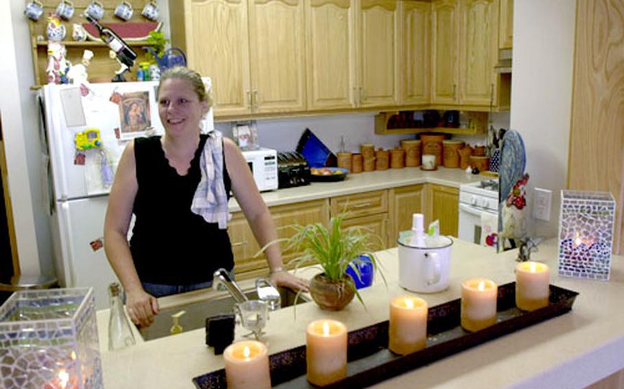 Cathy McGinn, a mother of six, stands in the kitchen of her new five-bedroom apartment in the Lloyd L. Burke Towers. Monday marked the opening ceremony for two new five-story housing towers on Yongsan Garrison’s south post. The McGinns used to live in Black Hawk Village.