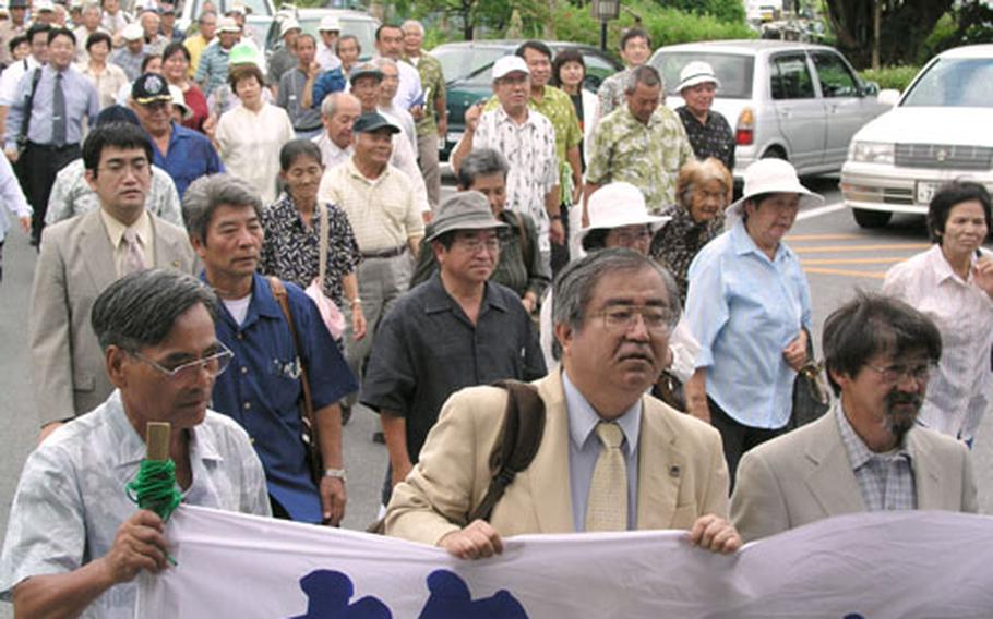 About 200 people take part in a demonstration Thursday in front of a Okinawa City court in support of residents suing the Japanese government over excessive noise from Kadena Air Base. Some 5,500 people living near the air base filed a lawsuit in March 2000 seeking suspension of night aircraft operations.