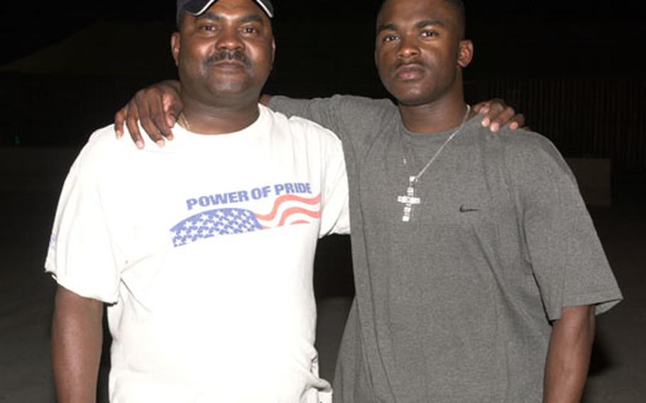 Spcs. Willie J. Butler Sr., left, and Willie J. Butler Jr. spent quality father/son time together on Camp Arifjan, Kuwait, as the elder Butler's unit passed through the base on its way back to the States.