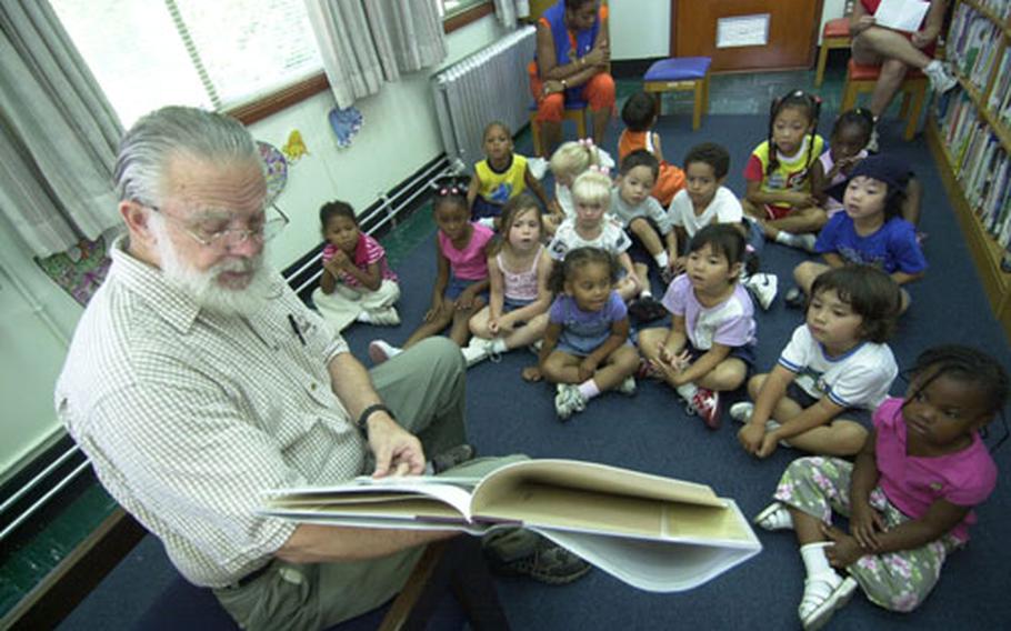 Volunteer Walter Reece reads to the children of Sagami Housing Area during story hour.