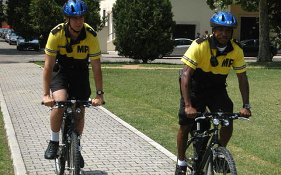 Military policemen Nathan Brumley, left, and Cyril Illidge aren't limited to the roads on Caserma Ederle or the nearby Villagio housing community when they conduct their bicycle patrols. A parking crunch and construction sometimes make the base a hard place to maneuver cars. Getting around on a bike is usually easier.