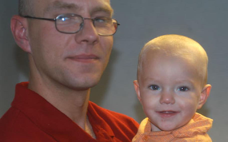 Staff Sgt. Michael Lecluyse of the 100th Communications Squadron at RAF Mildenhall, England, said seeing a little girl wounded by shrapnel in Iraq made him think of his two children, Delaney, 2, and Kyle, 13 months, seen here in Daddy's arms.
