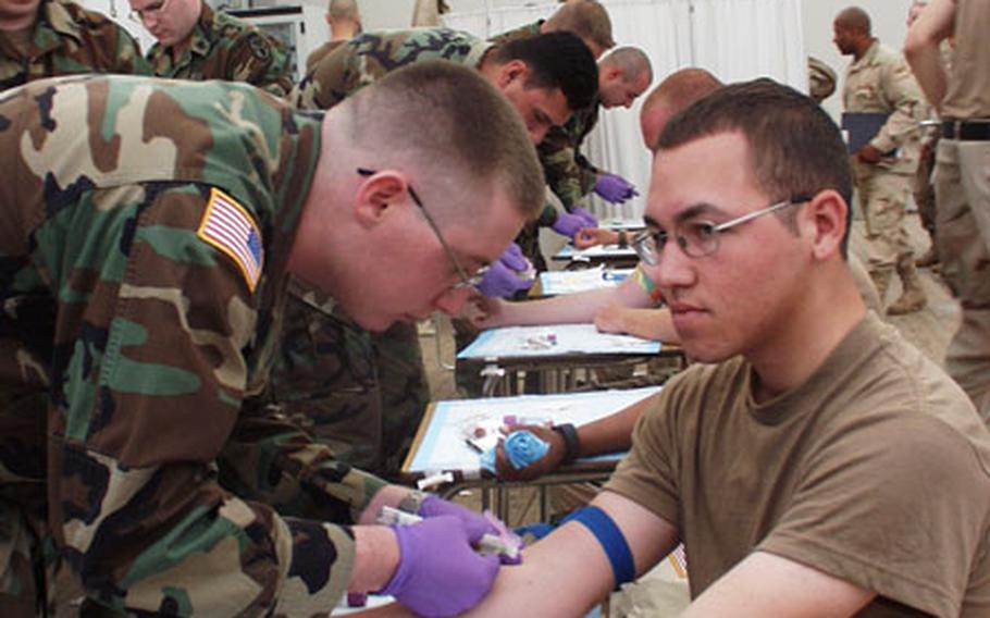 As the return of 1st Armored Division troops from Iraq goes into high gear, medical personnel at Smith Barracks in Baumholder, Germany, are conducting basic health screenings on hundreds of soldiers. The screenings are part of the Army's seven-day reintegration program. On Saturday, Spc. Dahlton R. Young, a lab technician, draws a blood sample from Pfc. Edxavier Rodriguez of Battery A, 1st Battalion, 94th Field Artillery Regiment.