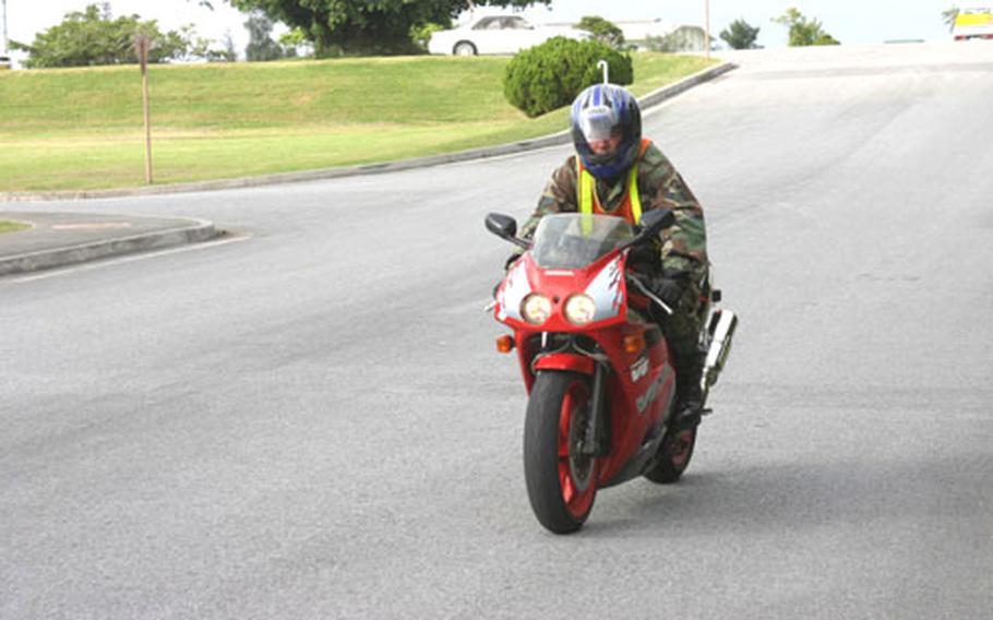 Airman 1st Class Andrew Junker, 20, from the 18th Logistics Readiness Squadron, Combat Mobility Element at Kadena Air Base rides his Honda VFR-400 Thursday on Kadena Air Base.