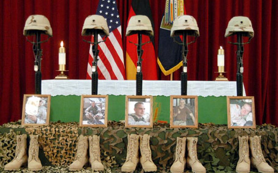 Helmets, rifles, dog tags, photos and boots of Sgt. Robert E. Colvill, Spc. Collier E. Barcus, Spc. Joseph M. Garmback Jr., Spc. William R. Emanuel IV and Spc. Sonny G. Sampler stand in front of the Ledward Barracks chapel altar at a memorial service Wednesday for the soldiers in Schweinfurt, Germany.