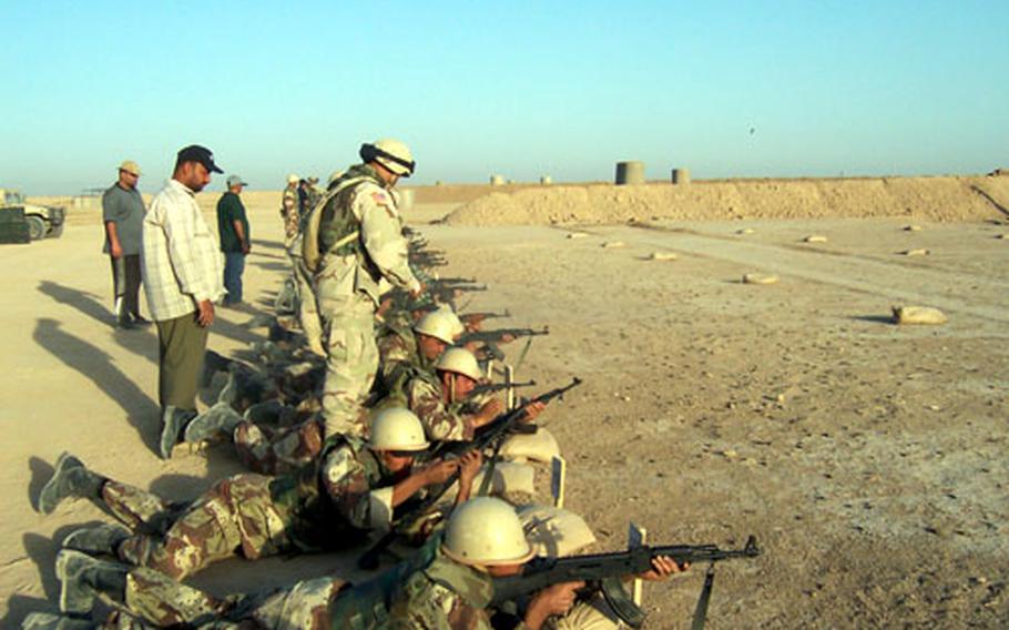 Iraqi National Guard soldiers qualify with AK-47 rifles at Butler Range, Forward Operating Base Warrior in June, as range personnel watch for safety violations.