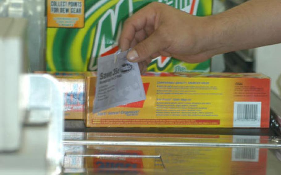 Gilbert Ramirez, 20, from Ontario, Canada, scans coupons at the commissary in Darmstadt, Germany. Commissaries in Europe have upgraded their technology to ensure the items purchased properly match the item featured on coupons. Coupons will still be accepted six months past the expiration date, according to the Defense Commissary Agency, Europe.
