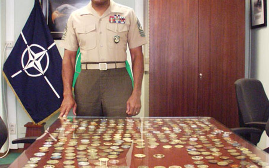 A year ago, at the urging of Gen. James L. Jones, Supreme Allied Commander Europe, Marine Corps Sergeant Major Alford L. McMichael delayed his retirement to become the first senior noncommissioned officer in history to represent NATO's enlisted force. Through the years, McMichael has accumulated hundreds of commemorative coins from units and individuals.